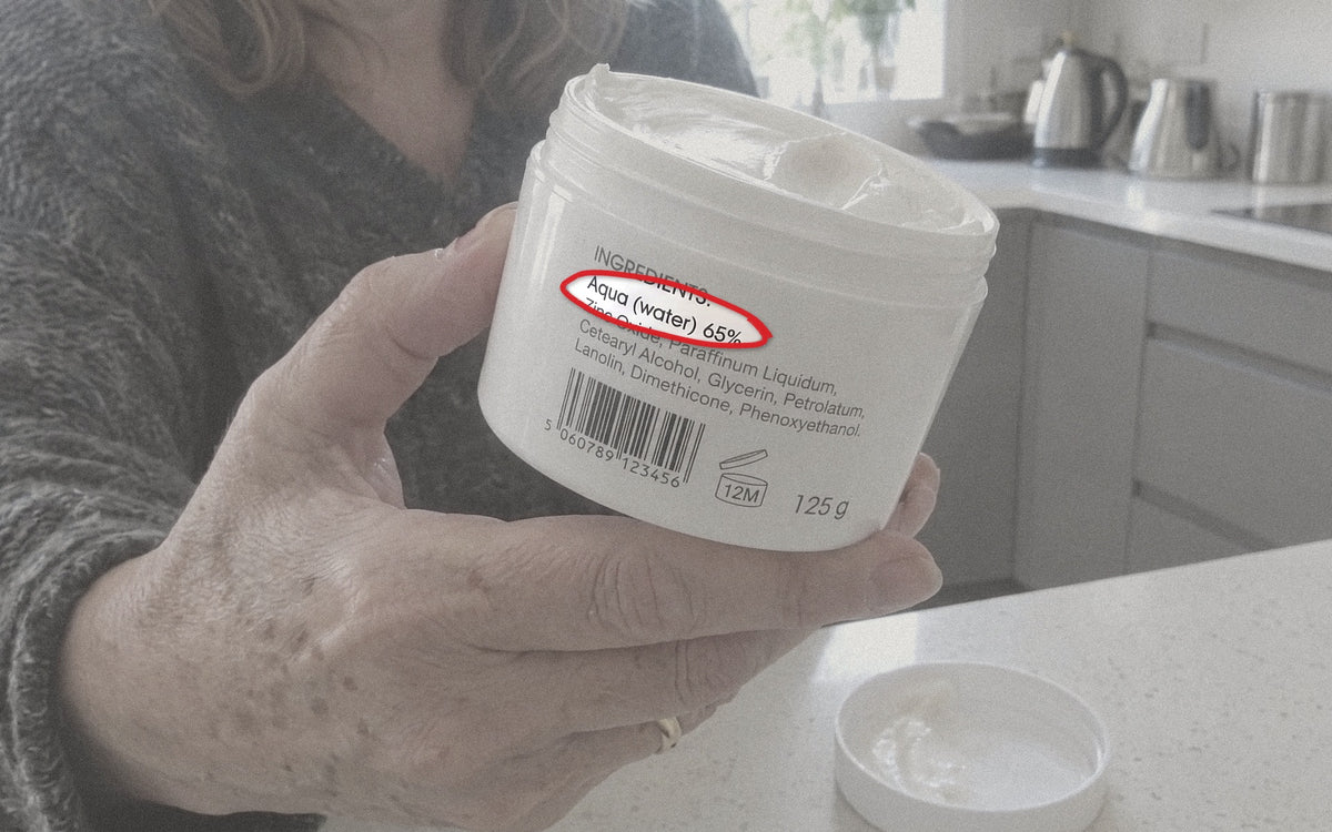 A bathroom shelf of creams and powder, with a close-up of a cream label